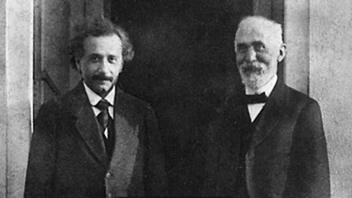 A couple of men in suitsDescription automatically generated